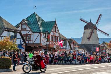 Santa and Mrs. Claus ride a motorcycle through Solvang.