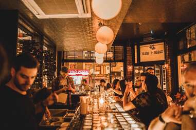 crowded bar in dim light at sager + wilde paradise row, london