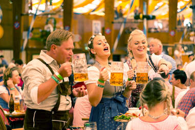people holding beer mugs