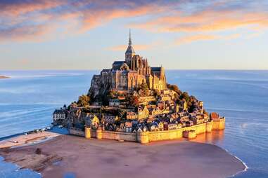 Mont Saint-Michel. Aerial view from the southeast during sunrise. Normandy, France.