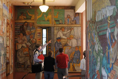 visitors tour the colorful murals at coit tower