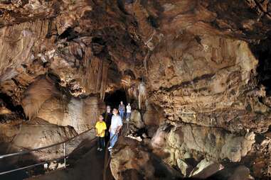 a family looks around a cave at lake shasta caverns in northern california