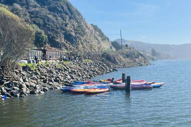 kayaks in the water near a rocky coastline in Northern California