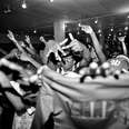 A black and white film photo of a rowdy concert in Washington, DC.