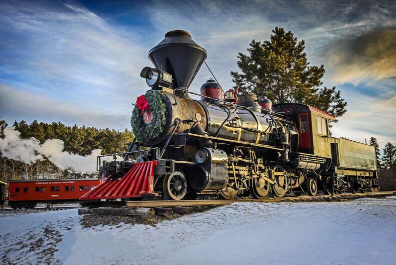 A train outfitted with a Christmas wreath.