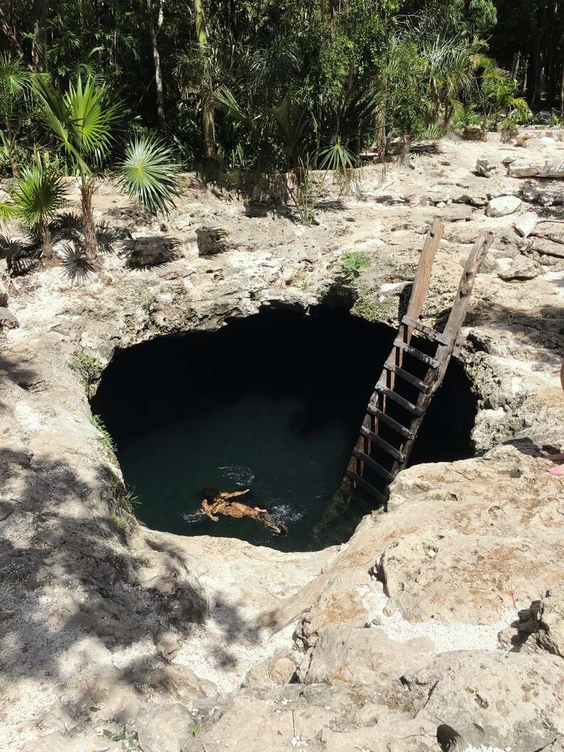 person floating in a natural swimming pool