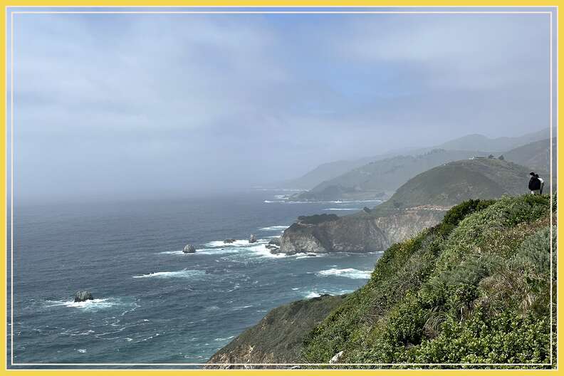 a turnout on pch between carmel and big sur, with people looking out from cliffs over the ocean